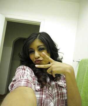 18 year old girl Katie Lewis stands naked after undressing in her bedroom